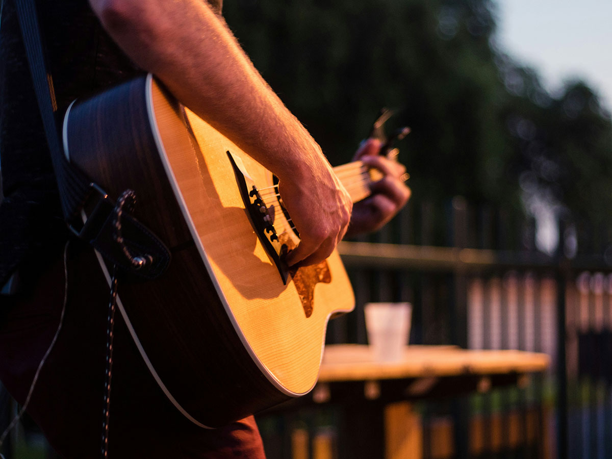 Playing an acoustic guitar